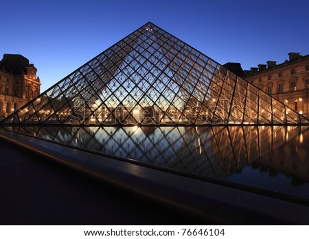 PARIS - APRIL 07: Louvre Pyramid shines at dusk on April 07, 2011 in Paris. Louvre is the biggest Museum in Paris displayed over 60,000 square meters of exhibition space.