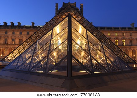 PARIS - APRIL 07: Louvre Pyramid shines at dusk on April 07, 2011 in Paris. Louvre is the biggest Museum in Paris displayed over 60,000 square meters of exhibition space.