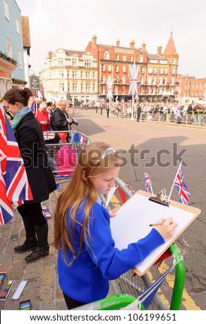 WINDSOR, BERKSHIRE, ENGLAND - MAY 19: Unidentified school girl drawing the Queens Diamond Jubilee Great Parade on May 19, 2012 in Windsor, Berkshire, England.