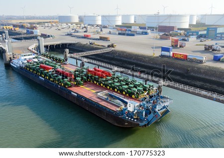 ROTTERDAM, SOUTH HOLLAND, NETHERLANDS - MARCH 28: Tractors loaded onto cargo barge in the Port of Rotterdam on March 28, 2013 in Rotterdam, South Holland, Netherlands.