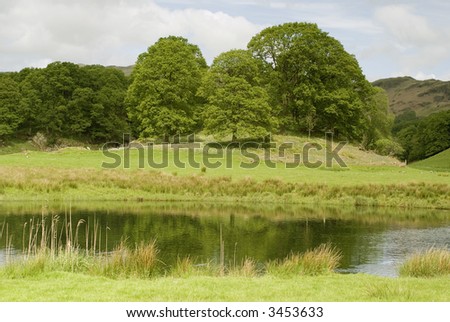 View across farmland to the fells in the Lake District - landscape orientation