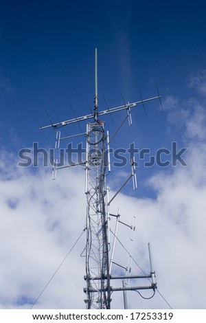 Radio communications tower isolated against blue sky
