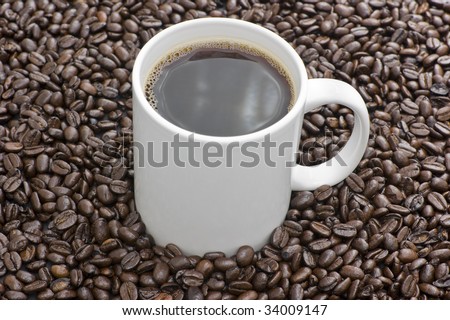 Fair Trade Pure Colombian whole coffee beans and white cup