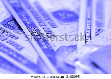 Credit card and dollars with shallow depth of field (blue tone)