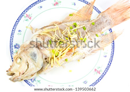 Steamed fish ginger on beautiful plate isolated on white background
