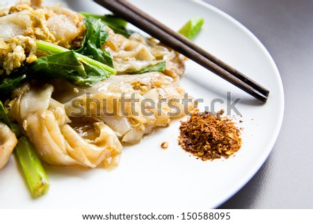 Thai fried noodle style with chili on white plate