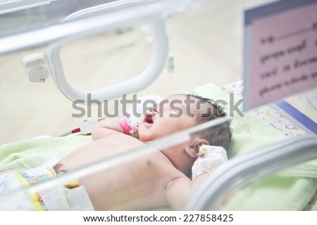 first day of asian newborn baby in Incubator care at nursery
