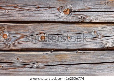 Old wooden logs as a part of wooden house walls