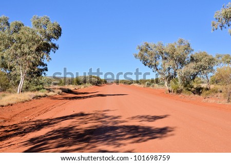 Gravel Road in the Australian Outback and Beautiful Blue Sky