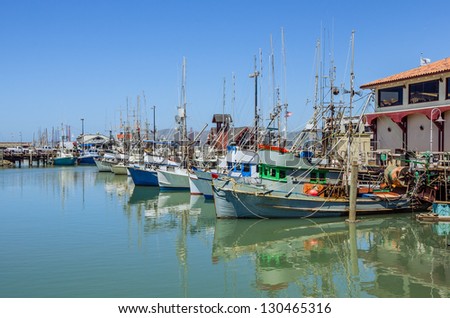 A Fleet of Fishing Boats in a Harbour and Blue Sky