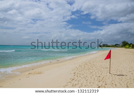 A Red Lifeguard Flag on a Deserted Beach in Barbados