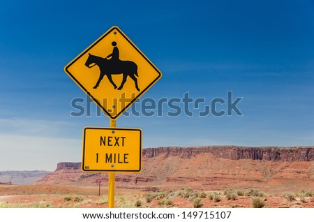 A Yellow Road Sign Warning About Horse Riders on the Road