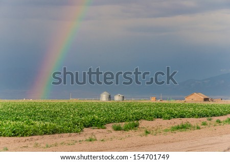 Rainbow and Storm Clouds over a Farm