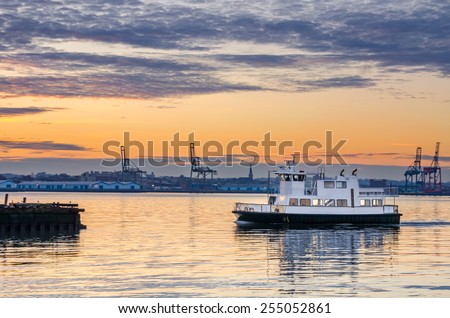 Sightseeing Boat Getting into the Harbour at Dawn. Motion Blur.