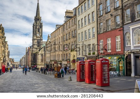 Edinburgh, Uk - March 28, 2015: Traditional Telephone booths on the Royal Mile. The Royal Mile runs downhill between the Castle and Holyrood Palace and is the busiest tourist street in the Old Town.