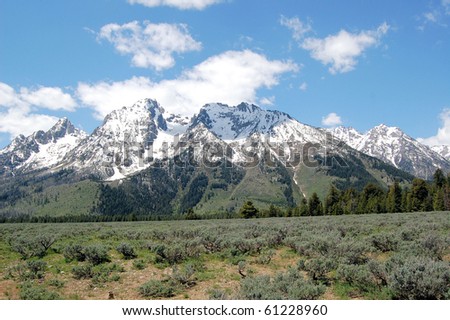 Mountain Landscape of Grand Teton National Park with Snow-capped Peaks and Blue Sky