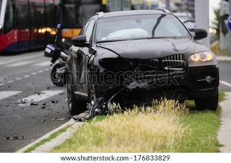 SERBIA, BELGRADE - MAY 12, 2013: Damaged black car after car accident with tram. The car did not give priority to tram