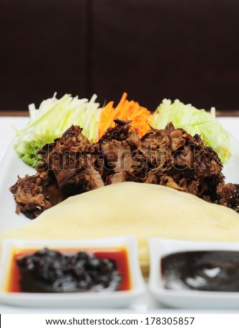 Peking Duck - Chinese roast duck served with cucumber, spring onion and hoisin sauce, wrapped in pancakes