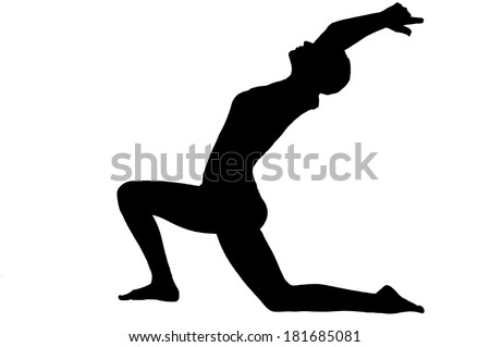 Silhouette of beautiful young woman in great shape practicing yoga
