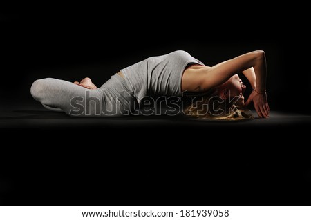 Beautiful young woman in great shape practicing yoga