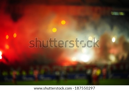 Blurred picture of soccer or football fans using pyrotechnics
