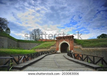 Old brick wall entrance gate and wooden bridge at Petrovaradin fortress, Novi Sad