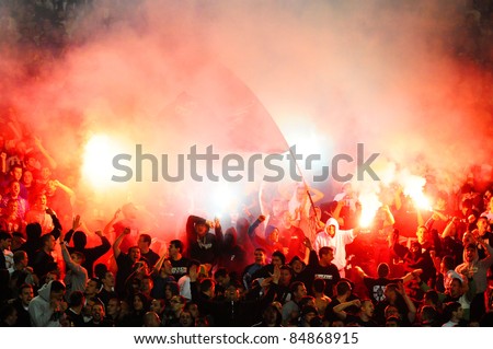 SERBIA, BELGRADE - MAY 11, 2011: Soccer or football fans celebrating goal with torches during Serbian cup final game between Vojvodina and Partizan