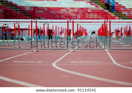 red running tracks with hurdles set up for training