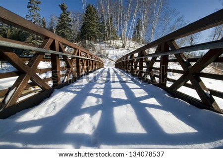 Foot bridge covered in snow with shadow of railing, Split rock lighthouse State Park, Minnesota