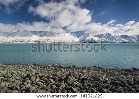 Fresh snow on mountains along Lake Pukaki, glacier water, low lake level, New Zealand