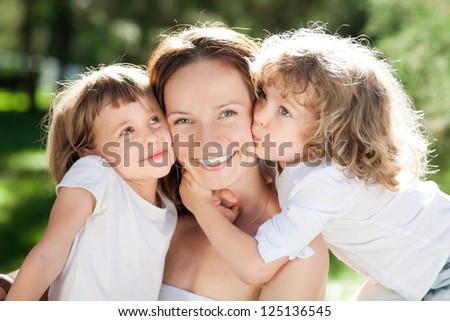 The young woman with two little girls in park