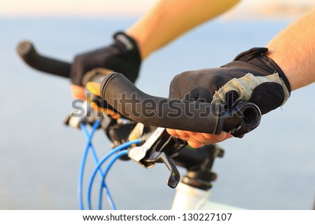 Hand of  racer on a bicycle wheel