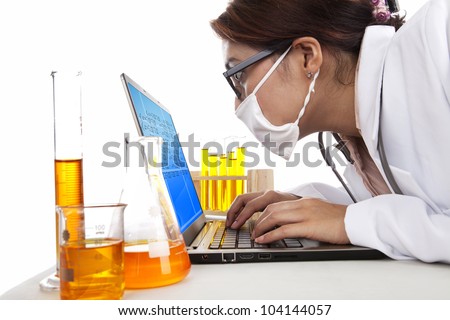 Lab assistant woman works with laptop and test-tubes in laboratory