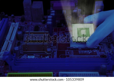 Technician hand installing the computer chip into a motherboard