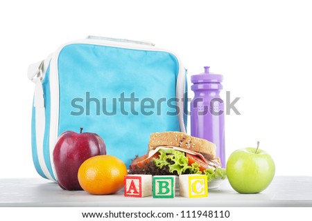 Closeup of a packed school lunch with alphabet blocks. shot in studio