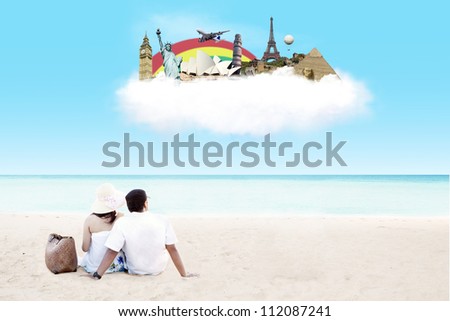 Young couple sitting together on beach with dreaming of travel destination on the cloud