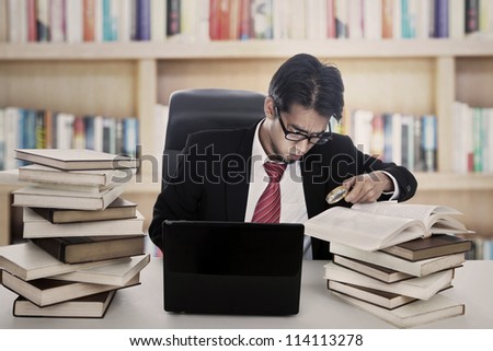 Portrait of successful businessman studying and happy with his result