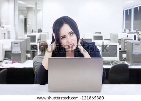 Businesswoman having difficult computer project while working in her office