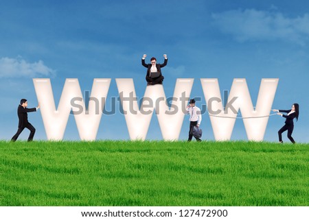 Business people using communication tools surround www letter on the green field