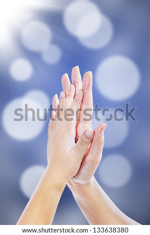 High five hand gestures between mother and son on blur background