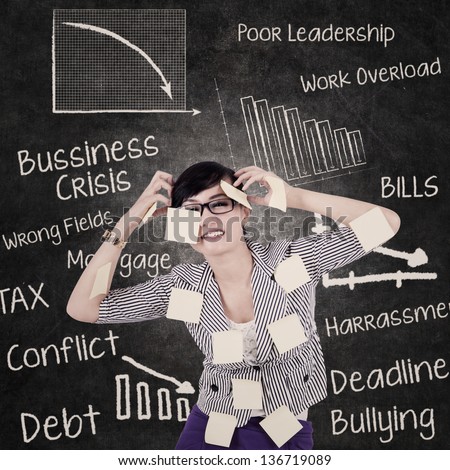 Stress business woman in front of blackboard