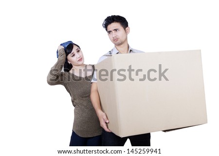 Confused Asian couple bring a large box on white background