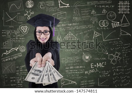Asian Female Graduate Giving Money In Classroom - Education Cost Concept