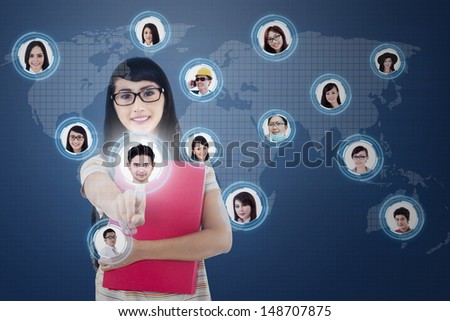 Close-up of a finger clicking on digital social network on blue background   (All model releases for 12 models are attached)
