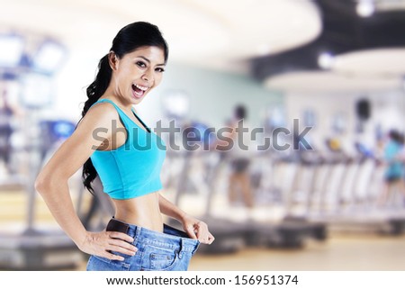 Expression of happy asian woman success to diet