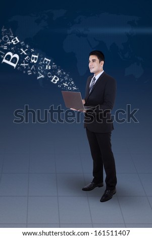 Young businessman working on his laptop, concept of internet chat and communication