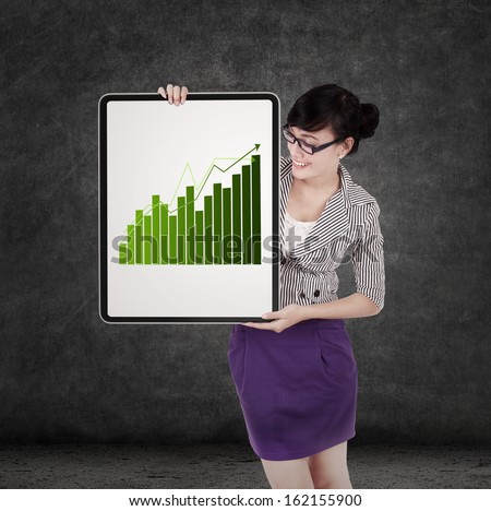 Successful business woman holding growth graph on board