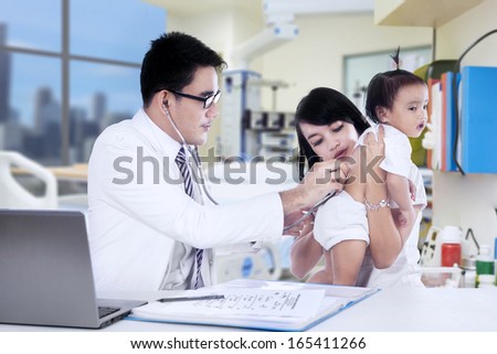 Asian mother and her daughter visiting doctor
