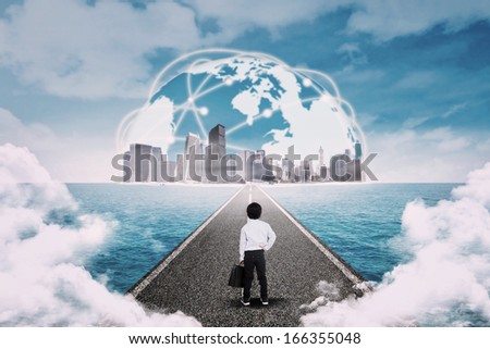 Business child standing on the road and looking a cityscape over ocean