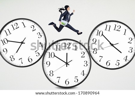 Businesswoman is running over clock by holding business paper